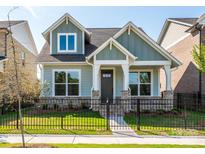 Charming craftsman-style home with a well-manicured lawn and a black metal fence at 17025 Malone Ln, Mint Hill, NC 28227