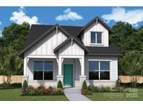 Charming two-story home featuring light siding, black roof, and a inviting front porch at 17025 Malone Ln, Mint Hill, NC 28227