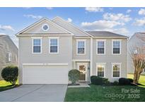 Charming two-story home with a manicured lawn and attached two-car garage at 1906 Hamilton Forest Dr, Charlotte, NC 28216