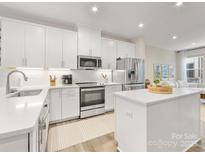 Well-equipped kitchen featuring sleek white cabinets, stainless steel appliances, and an island at 4010 Citra Ln, Charlotte, NC 28217