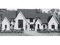 Charming craftsman-style home with a white exterior, gabled roof, and well-manicured landscaping at 620 Deodar Cedar Dr, Weddington, NC 28104