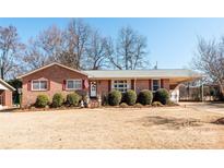 Charming brick home with a covered carport and landscaped front yard at 662 University Dr, Rock Hill, SC 29730