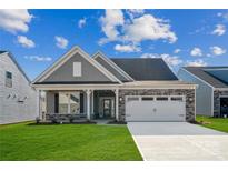 Charming single-story home featuring stone accents, a two-car garage, and a well-maintained lawn at 9096 El Sworth Dr, Sherrills Ford, NC 28673