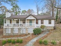 Charming ranch-style home featuring a welcoming front porch and a beautifully landscaped yard at 10031 Bora Bora Dr, Tega Cay, SC 29708