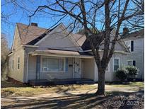 Charming one-story home with a classic design, inviting front porch, and mature tree in the front yard at 110 2Nd St, Spencer, NC 28159