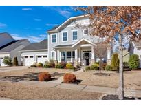Charming two-story home featuring a well-manicured front yard and a two-car garage at 2172 Paddlers Cove Dr, Clover, SC 29710