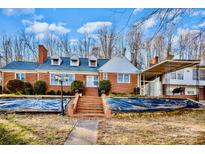 Charming brick home with a covered carport and inviting front entrance staircase at 401 N Inman Ave, Bessemer City, NC 28016
