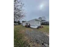 Charming single-story home features a gravel driveway and well-maintained lawn at 412 Sumter St # A, Clover, SC 29710