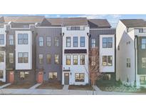 Modern townhome featuring varied textures in gray and white with a small front yard landscaping space at 429 Blairhill Rd # 09, Charlotte, NC 28217