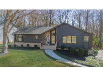 Charming single Gathering home with stone accents, modern siding, manicured lawn, and mature trees at 6049 Old Providence Rd, Charlotte, NC 28226