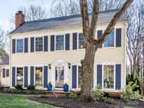 Charming two-story home featuring classic shutters, a brick chimney, and a well-manicured front lawn at 605 Heathermoor Ct, Charlotte, NC 28209