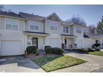 Charming townhome exterior featuring well-maintained landscaping, attached garages, and inviting curb appeal at 6672 Vlosi Dr, Charlotte, NC 28226