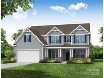 Charming two-story home featuring a covered front porch, blue siding, and a well-manicured lawn at 8712 Acadia Pkwy # 595, Sherrills Ford, NC 28673