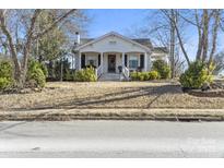 Charming bungalow with a covered front porch and inviting curb appeal in a residential neighborhood at 940 N New Hope Rd, Gastonia, NC 28054