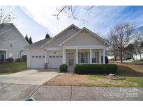 Charming single-story home featuring an attached two-car garage and a cozy covered front porch at 1004 Kensrowe Ln, Matthews, NC 28104