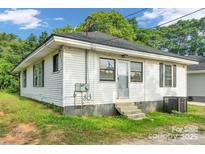 Charming single-story house featuring white siding, black shutters and a well-maintained yard at 1261 Springdale Rd, Lancaster, SC 29720