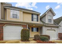 Charming townhome features neutral siding, a brick accent, and an attached one-car garage at 1386 Walnut Hill Dr, Rock Hill, SC 29732