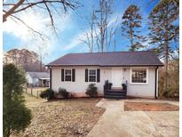 Charming one-story home featuring black shutters, a walkway, and inviting front entrance at 1545 Player Ct, Gastonia, NC 28054