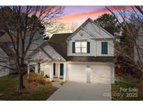 Charming two-story home with a two-car garage and beautiful sunset sky at 18016 Bluff Inlet Rd, Cornelius, NC 28031
