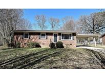 Charming brick home with a covered carport and well-maintained landscaping at 1961 Franklin St, Rock Hill, SC 29732