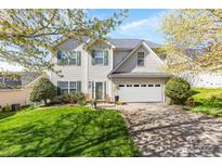 Charming two-story home with green shutters, blooming trees, a well-manicured lawn and a two-car garage at 2988 Clover Nw Rd, Concord, NC 28027