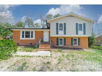 Charming two-story home features a brick and vinyl exterior with bright windows and a well-manicured lawn at 6126 Eagle Peak Dr, Charlotte, NC 28214