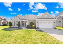 Charming one-story home featuring manicured lawn, landscaped entryway and a two car garage at 7362 Vanguard Ct, Stanley, NC 28164