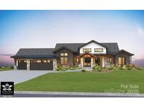 Stunning new construction featuring a modern farmhouse design, three-car garage, and manicured front yard at Lot 17 Ridgeview Ln, Iron Station, NC 28080