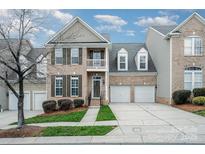 Charming brick two-story home features a balcony and a two-car garage at 10349 Linksland Dr, Huntersville, NC 28078