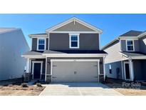 Charming two-story home with a modern exterior and a two-car garage at 1102 Harry Ct, Albemarle, NC 28001