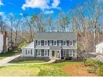 Charming two-story home with classic gray siding, black shutters, and a well-manicured front lawn at 1133 Bloom Wood Ln, Matthews, NC 28105