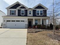 Charming two-story home with a two-car garage, landscaped yard, and covered front porch at 228 Heatherland Dr, Rock Hill, SC 29732