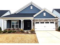 Charming home featuring a stone and shingle facade with a two-car garage and well-manicured landscaping at 2617 Manor Stone Way, Indian Trail, NC 28079