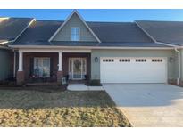 Charming home features a two-car garage and a welcoming front porch at 773 Iris Ln, Newton, NC 28658