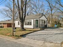 Charming one-story house with black trim, covered porch and a gravel driveway at 811 Austin St, Albemarle, NC 28001