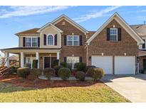 Beautiful brick two-story home with manicured landscaping and a two-car garage at 9623 Laurie Nw Ave, Concord, NC 28027