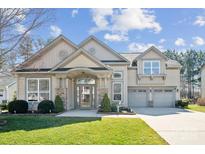 Charming two-story home with a well-manicured lawn and a welcoming entrance and two-car garage at 1121 Mckee Farm Ln, Belmont, NC 28012