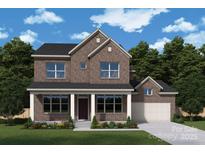 Beautiful two-story brick home featuring a covered porch and attached two-car garage at 13126 Macon Hall Dr, Mint Hill, NC 28227