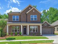 Beautiful brick home featuring a manicured lawn and a two-car garage at 13126 Macon Hall Dr, Mint Hill, NC 28227
