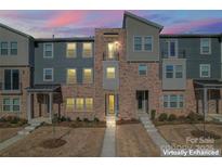 Charming townhome exterior with a blend of modern and traditional architectural elements under a dusk sky at 1645 Unison Dr, Charlotte, NC 28262