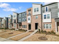 Attractive townhome with well-maintained landscaping, offering curb appeal and modern design at 1645 Unison Dr, Charlotte, NC 28262