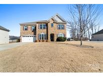 Charming two-story brick home featuring a two-car garage and well-manicured front yard at 193 Sassafras Rd, Mooresville, NC 28115