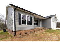 Charming one-story home with gray siding, black shutters, brick foundation, and well-manicured front lawn at 203 S Hill Ave # 3, Albemarle, NC 28001
