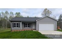 Charming gray home with a white garage door, well-manicured lawn, and black shutters, offering a cozy curb appeal at 203 S Hill Ave # 3, Albemarle, NC 28001