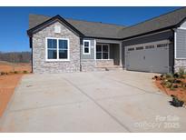 Charming single-Gathering home with a stone facade, gray siding, and a two-car garage at 2063 Fordhill St, Rock Hill, SC 29732