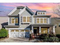 Charming two-story home featuring a craftsman-style facade, stone accents, and a two-car garage at 3004 Fallondale Rd, Waxhaw, NC 28173
