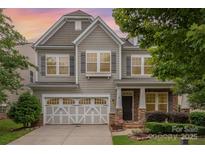 Charming two-story home featuring a two-car garage, stone accents, and manicured landscaping at 3004 Fallondale Rd, Waxhaw, NC 28173