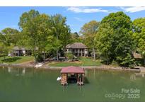 Stunning waterfront estate with a private dock and lush landscaping at 4786 Heather Ln, Denver, NC 28037