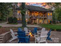Outdoor fire pit area with Adirondack chairs provides a relaxing backyard entertainment space at 4786 Heather Ln, Denver, NC 28037