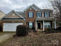 Charming two-story home with a two car garage, brick and vinyl siding and blue shutters at 6237 Shelley Ave, Charlotte, NC 28269